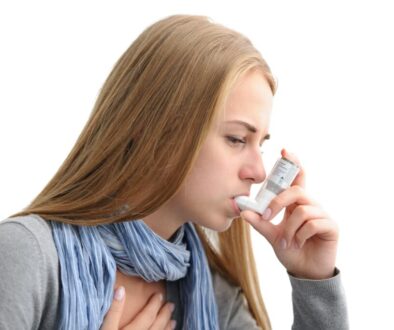 Young woman using an asthma inhaler as prevention